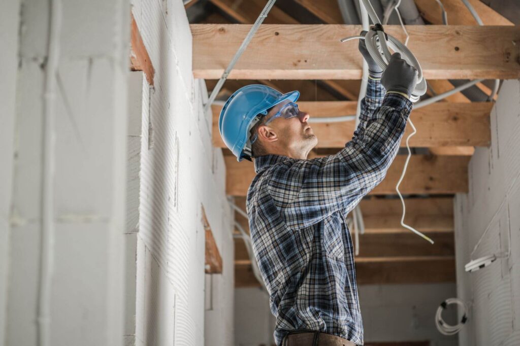 electrician rewiring an electrical system